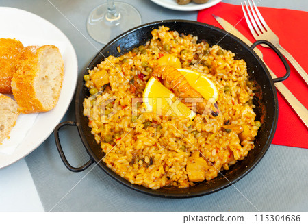 Paella in frying pan 115304686