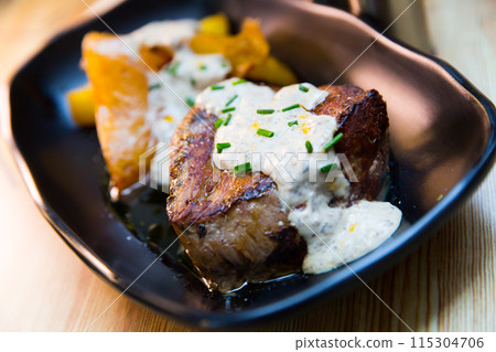 Veal sirloin with baked potato and mushroom sauce Veal sirloin with baked potato and mushroom sauce 115304706