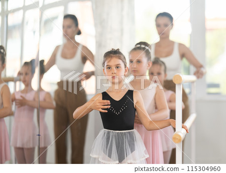 Ballet choreographer teaches little children to get into first position Ballet choreographer teaches little children to get into first position 115304960