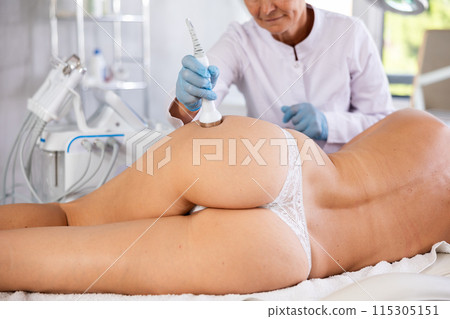 Anti-cellulite procedure on buttocks of young woman in beauty clinic Anti-cellulite procedure on buttocks of young woman in beauty clinic 115305151