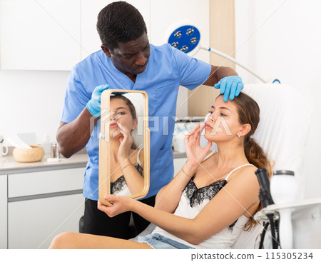Doctor giving consultation about injection for lips to female patient 115305234