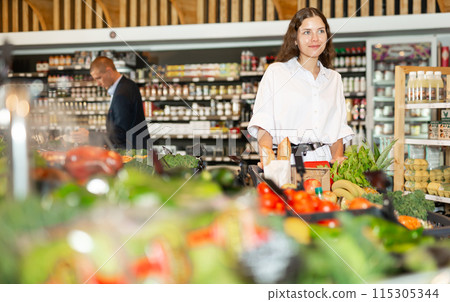 Woman shopping at grocery department at supermarket 115305344