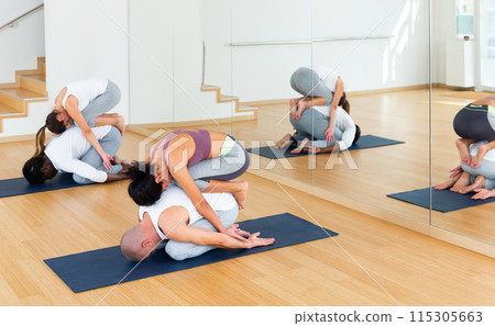 Couples practicing yoga with partner at studio Couples practicing yoga with partner at studio 115305663