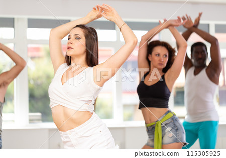 Group of men and women dancing in studio 115305925