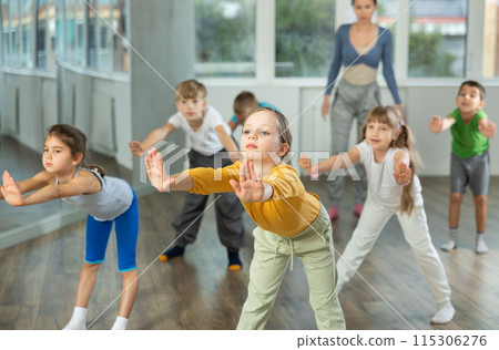 Girl enjoys dancing, learning to twerk during group class at studio school for children 115306276
