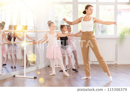 Female teacher shows choreography to group of girls Female teacher shows choreography to group of girls 115306379