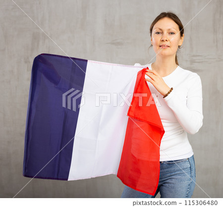 Adult cheerful woman holding France flag Adult cheerful woman holding France flag 115306480