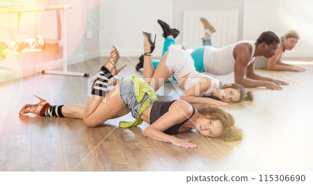 Women performing high heels choreography during group dance class Women performing high heels choreography during group dance class 115306690