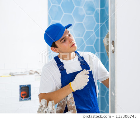 Young tiler working with ceramic tiles for interior decoration of repairable room Young tiler working with ceramic tiles for interior decoration of repairable room 115306743