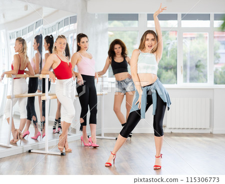 Female dancer performing solo high heels dance in studio 115306773