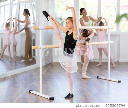 Girls dancers doing stretching at barre 115306794