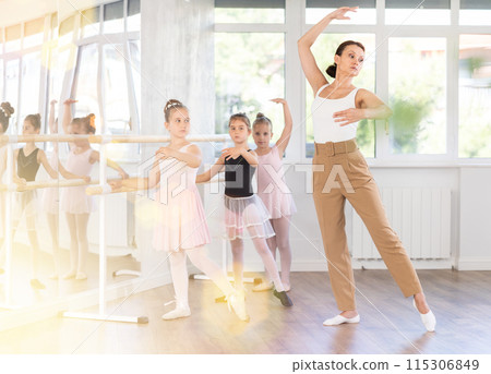 Teacher dancer performing pirouette in front of class 115306849