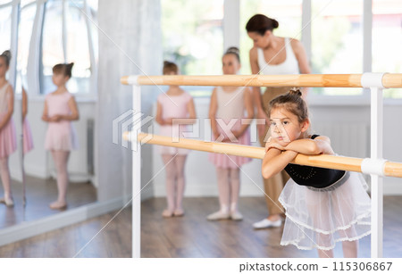 Girl dancer resting at ballet barre 115306867