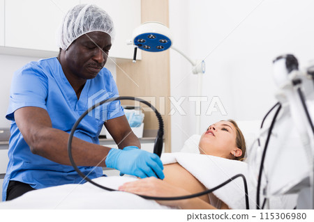 Young beautiful woman getting body ultrasound lifting procedure 115306980