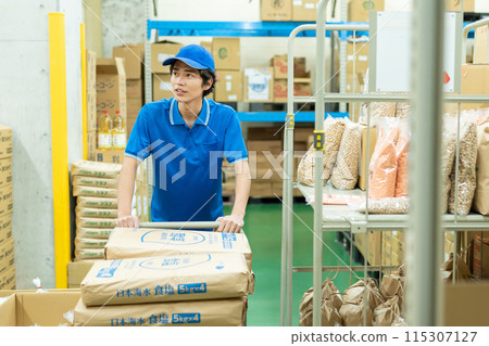Young male driver working in warehouse Young male driver working in warehouse 115307127