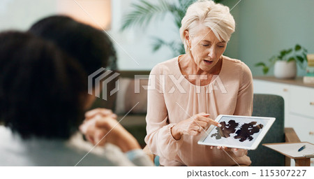 Therapist, patient and inkblot test in therapy for psychology analysis and mental health assessment on tablet. Psychologist, senior woman and digital tech with rorschach image for emotional disorder Therapist, patient and inkblot test in therapy for psychology analysis and mental health assessment on tablet. Psychologist, senior woman and digital tech with rorschach image for emotional disorder 115307227