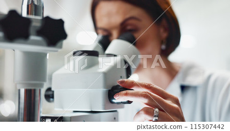 Hands, woman and scientist by microscope with research for cancer treatment at pharmaceutical lab. Person, study and innovation for drugs, medication or dial for zoom, results and chemical solution 115307442