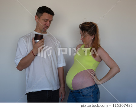 Expecting parents eagerly await their baby's arrival, holding the first ultrasound Expecting parents eagerly await their baby's arrival, holding the first ultrasound 115307485