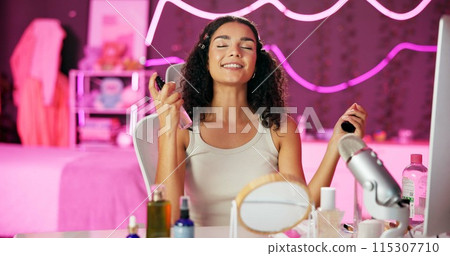 Makeup, influencer and woman in bedroom for live stream, beauty tutorial, review product. Spray bottle, cosmetics and person broadcast for social media, communication or filming routine in home Makeup, influencer and woman in bedroom for live stream, beauty tutorial, review product. Spray bottle, cosmetics and person broadcast for social media, communication or filming routine in home 115307710