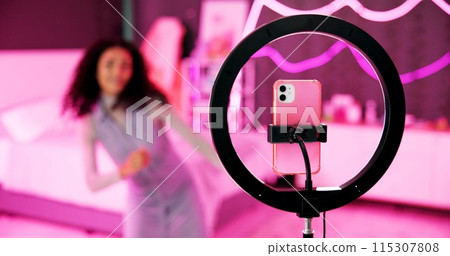 Girl, dancer and ring light for live stream for social media, connection or audience for online. Female person, influencer and bedroom with tripod for video, content creation and tech at home for app 115307808