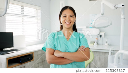 Face, dentist and arms crossed with asian woman in scrubs at hospital for dental care or oral hygiene. Portrait, smile for medical and happy young orthodontist professional at clinic for dentistry 115307817