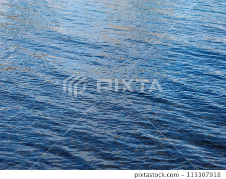 Ocean Water ripples off the coast of Oahu reflecting light 115307918