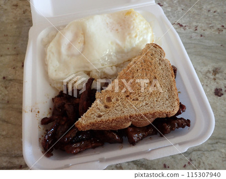 Kalbi, two eggs over easy on top of two scoops of rice and two slices of wheat bread breakfast Kalbi, two eggs over easy on top of two scoops of rice and two slices of wheat bread breakfast 115307940
