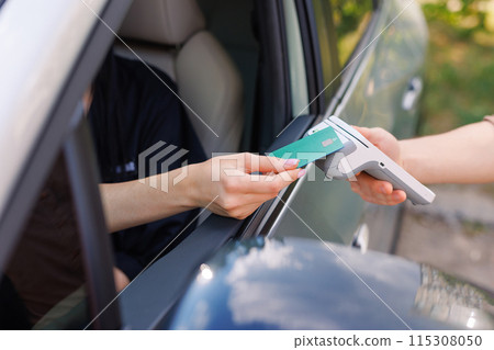 the driver makes contactless NFC payment with a credit card 115308050