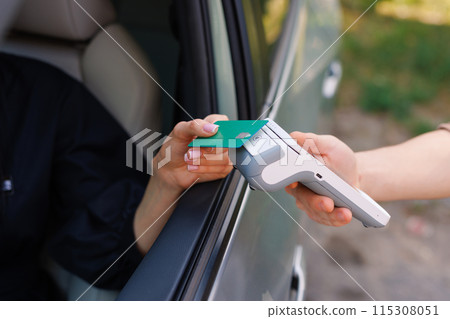 the driver makes contactless NFC payment with a credit card 115308051