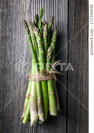 Bunch of fresh green asparagus sprouts on old rustic table 115308086