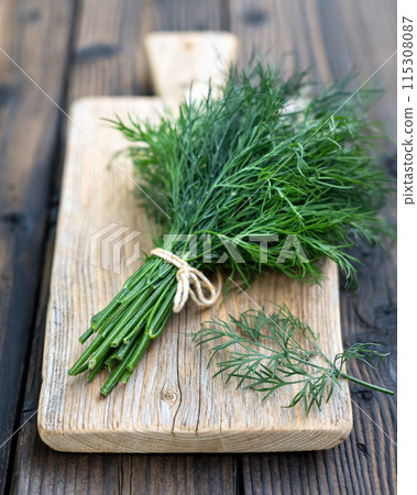 Bunch of green fresh fragrant dill on wooden board 115308087