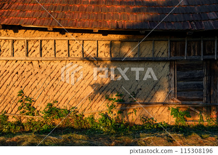 Old rural Ukrainian wooden-clay house with tiled roof 115308196