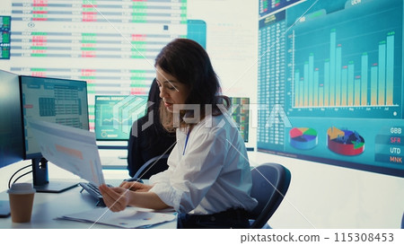 Enterprise worker examines project updates and details in control room, allocate resources and solve tasks to achieve strategic business goals, organizational corporation operations. Camera B. Enterprise worker examines project updates and details in control room, allocate resources and solve tasks to achieve strategic business goals, organizational corporation operations. Camera B. 115308453