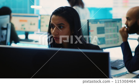 Indian office administrator explores partnership opportunities for the global business expansion plans, establishing current enterprise objectives. Analyst doing a win or loss study. Camera A. 115308464