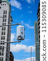Traffic lights between buildings 115309085
