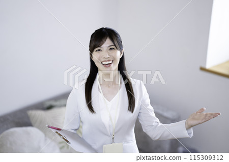 Female staff showing a model room 115309312