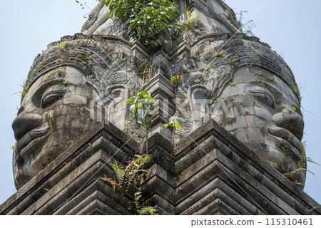 Ancient Buddha face statue on the stone building Ancient Buddha face statue on the stone building 115310461
