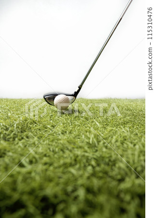 Closeup view of a golf ball with a golf club 115310476