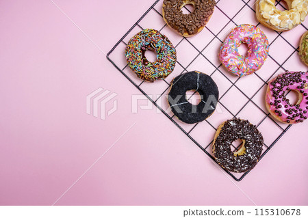 Various delicious donuts with different sprinkled decorations 115310678