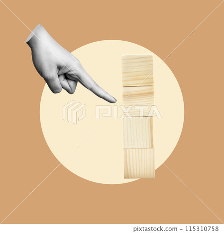 Hand pointing at wooden blocks concept 115310758