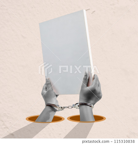 A man is holding a white piece of paper with handcuffs on it 115310838