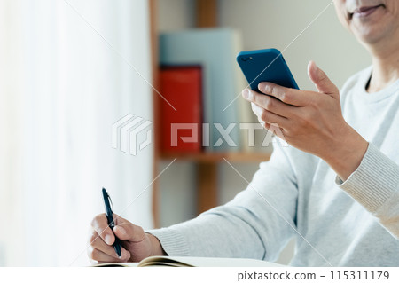 Middle-aged man checking his smartphone Middle-aged man checking his smartphone 115311179