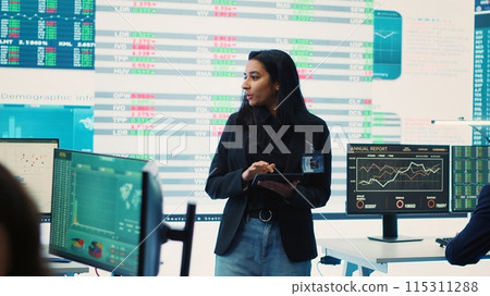 Enterprise manager looking into project updates and details in monitoring room, establishing resource allocation plans to achieve strategic business goals. Corporation operations. Camera A. Enterprise manager looking into project updates and details in monitoring room, establishing resource allocation plans to achieve strategic business goals. Corporation operations. Camera A. 115311288