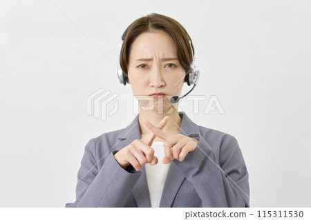 Operator making a cross gesture with his hand on a white background Operator making a cross gesture with his hand on a white background 115311530