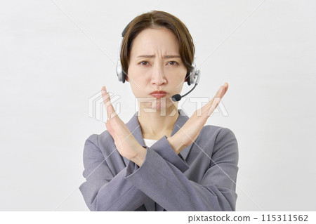 Operator making a cross gesture with his hand on a white background Operator making a cross gesture with his hand on a white background 115311562