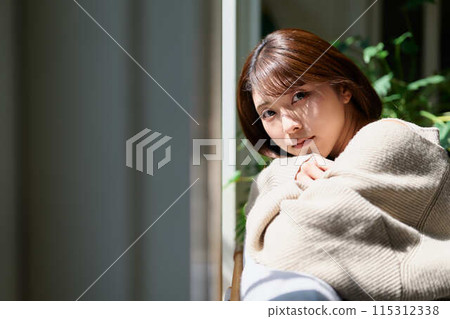 A woman sleeping by the window in the sunlight A woman sleeping by the window in the sunlight 115312338