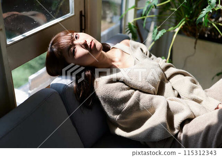A woman sleeping by the window in the sunlight A woman sleeping by the window in the sunlight 115312343