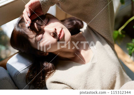A woman sleeping by the window in the sunlight A woman sleeping by the window in the sunlight 115312344