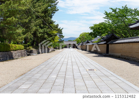 On a clear day in Nara, the stone pavement stretches from the Western Precinct to the Eastern Precinct of the World Heritage and National Treasure, Horyu-ji Temple. On a clear day in Nara, the stone pavement stretches from the Western Precinct to the Eastern Precinct of the World Heritage and National Treasure, Horyu-ji Temple. 115312482