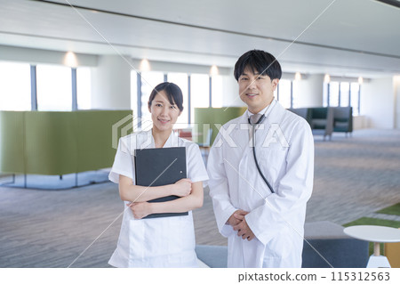 Smiling male doctor and nurse talking at the hospital 115312563